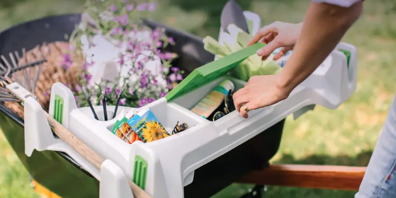 Burro Buddy on wheelbarrow with storage compartment open